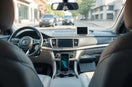 Modern car interior with curated accessories including a phone mount and organizer on the console
