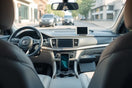 Modern car interior with curated accessories including a phone mount and organizer on the console