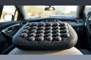 Massage cushion with multiple node zones placed on a car seat for comfortable support