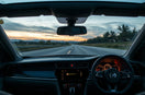 Modern car dashboard with digital instruments and heads-up display glow