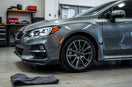 Glossy car exterior with alloy wheels and subtle LED accents in a clean garage setting