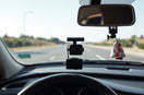 4K dual lens dash cam mounted on a car windshield with the road visible ahead