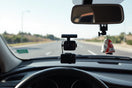 4K dual lens dash cam mounted on a car windshield with the road visible ahead