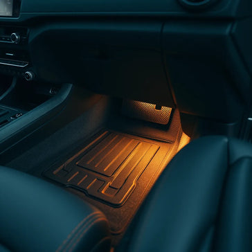 Modern car interior with custom accessories like trim accents, mats, and a phone mount