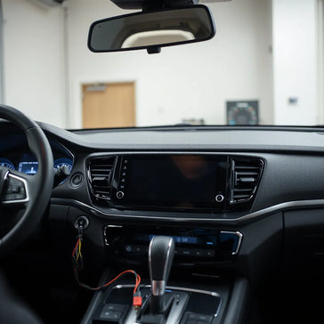 Modern car dashboard electronics with an infotainment screen and visible connectors for reliable upgrades
