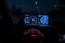Transparent heads-up display projects driving metrics onto the windshield in a modern car interior