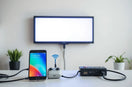Phone wirelessly controlling a glowing LED display with neatly connected cables