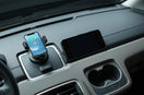 Modern car interior with a phone mount charger and compact safety accessories on the dashboard