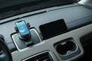 Modern car interior with a phone mount charger and compact safety accessories on the dashboard