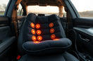 Heated car massage cushion on a car seat with subtle warmth and visible massage nodes