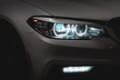 gray car with white and blue lights