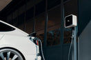 a white car plugged in to a charging station
