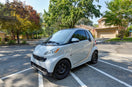 a smart car parked in a parking lot