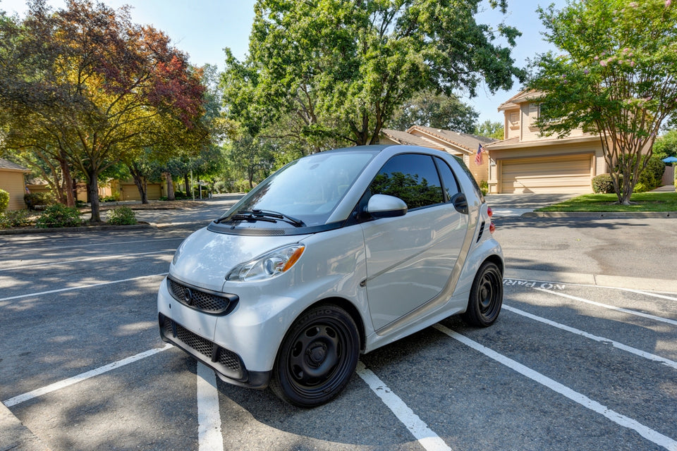 a smart car parked in a parking lot