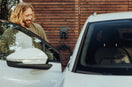 a man standing next to a white car