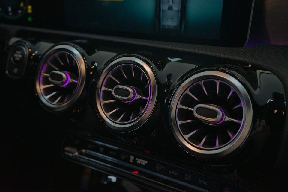 Close-up of car air vents with ambient lighting