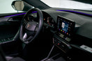 Modern car interior with illuminated dashboard and touchscreen.