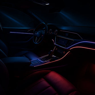 A car with upgraded LED headlights and interior ambient lighting shown at night.