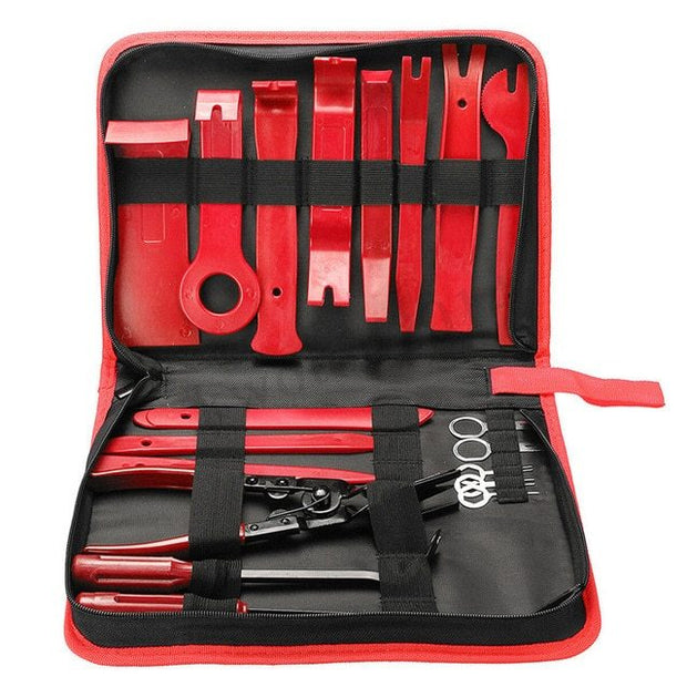 Open black and red tool bag with red plastic pry tools and metal pliers inside.