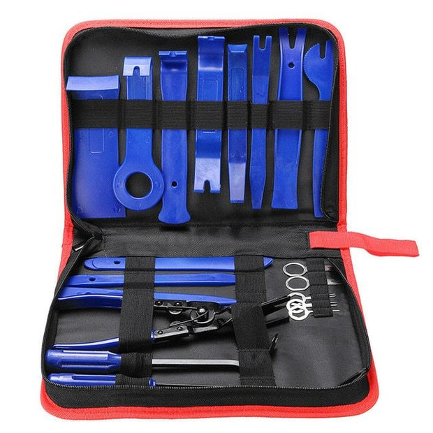 An opened red-and-black nylon tool kit, revealing an array of blue plastic trim removal tools, pliers, and metal trim retainers.